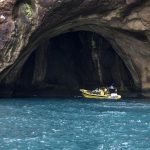 best sightseeing tour South Iceland A picture of a boat by a cave in the Westman Islands