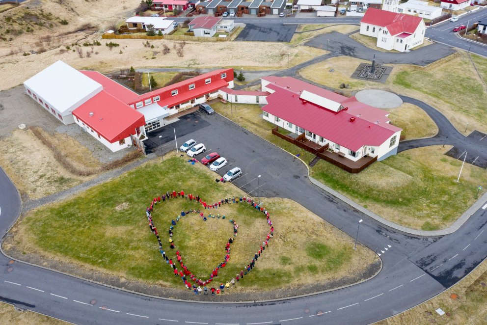 Kids Stand In Heart Shape Outside Retirement Community