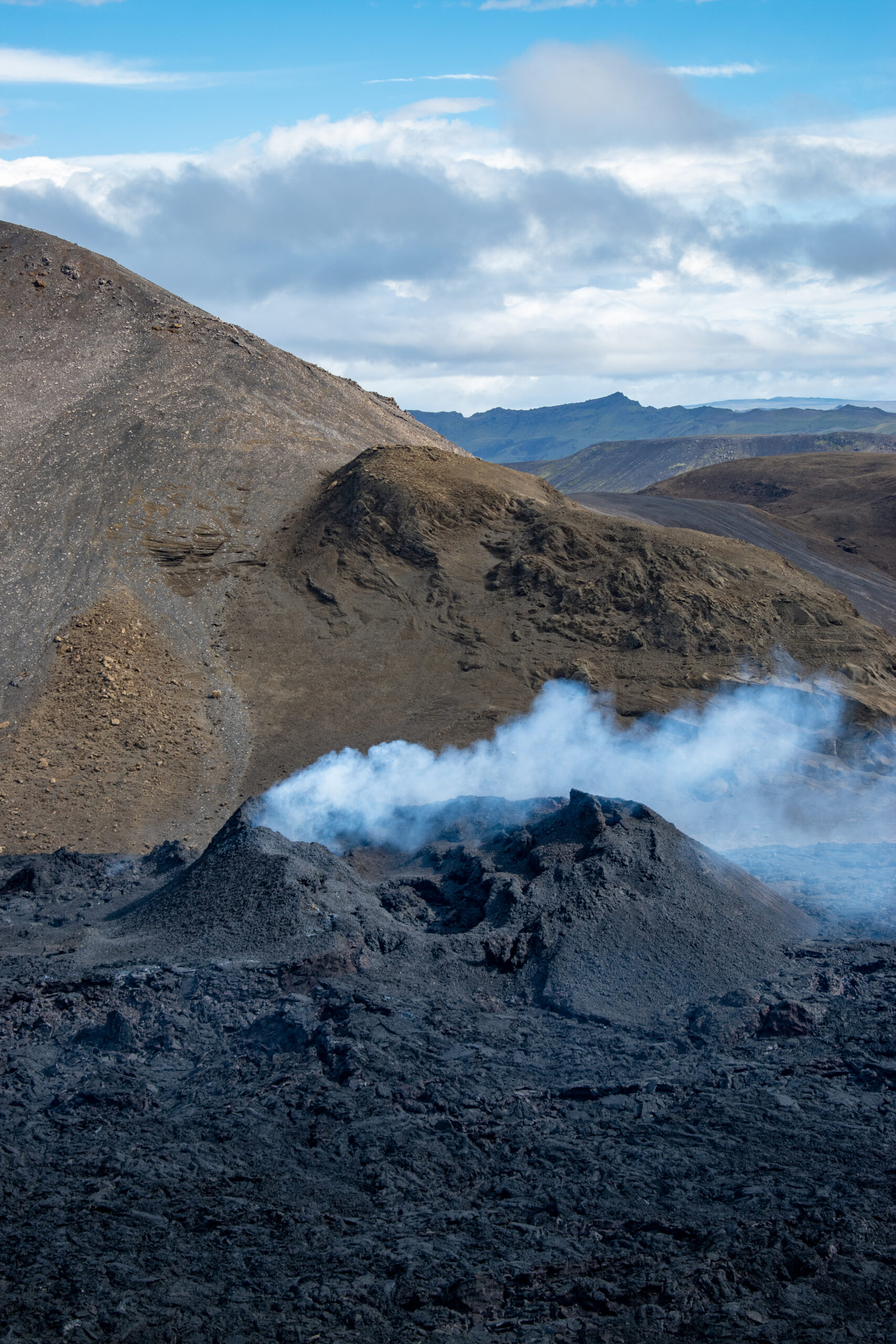 On Saturday, August 20, blue-gray smoke rises from an inactive crater.