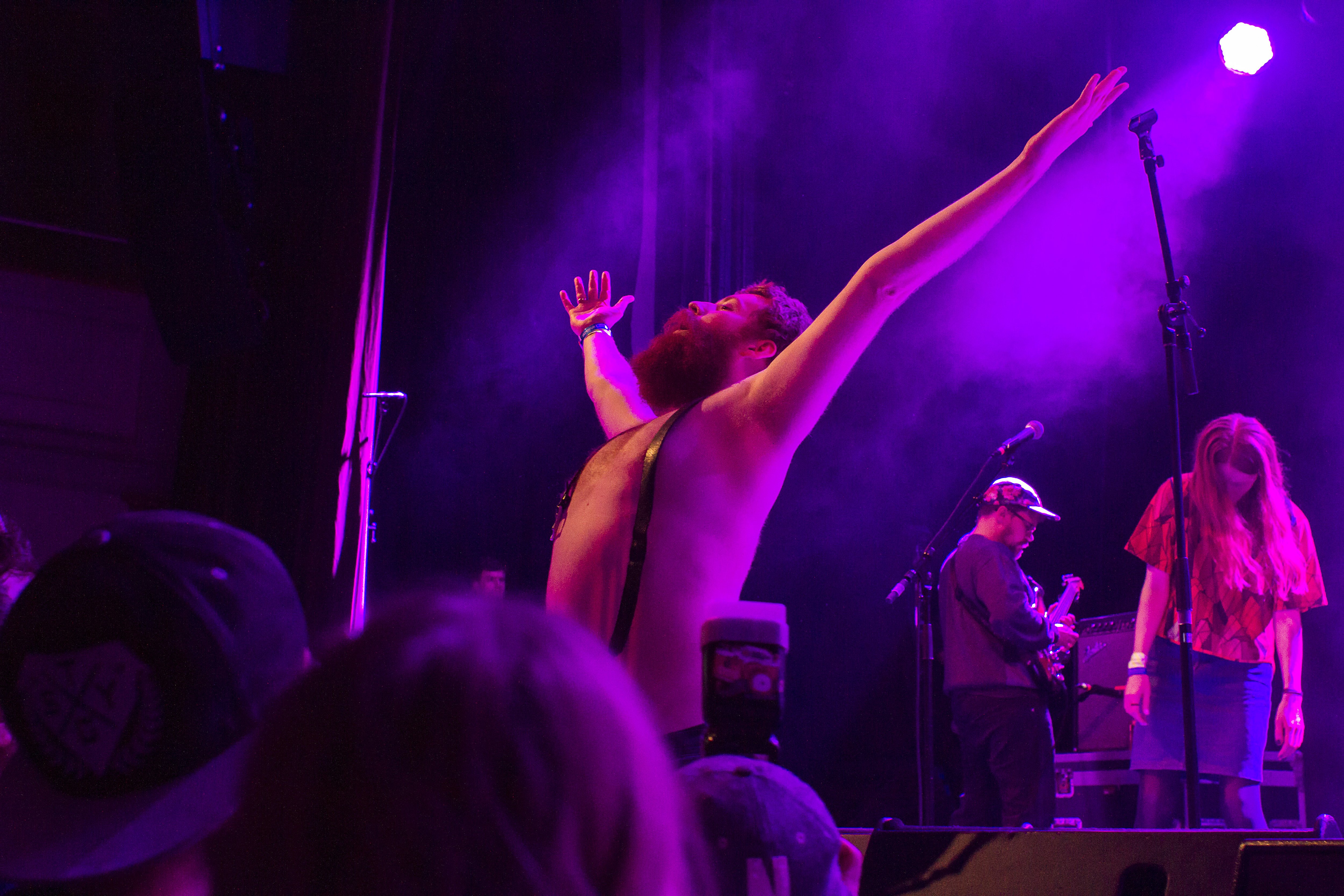 Lead singer of Berndsen, topless, raising his skinny fists to the heavens like antennas to the sky